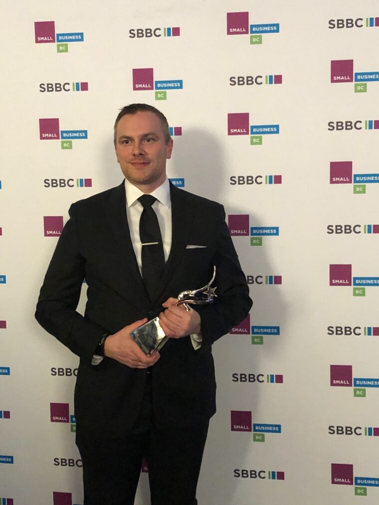 Chris Stephens holding Twirling Umbrellas’ 2020 Small Business BC award
